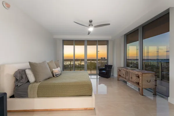 a bedroom with a large bed and a balcony view