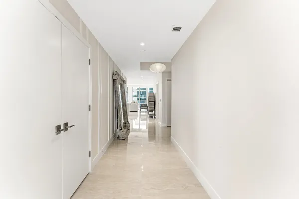 a view of a hallway with wooden shelves