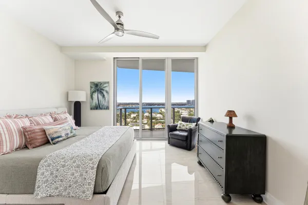 a bedroom with a bed couch and a window