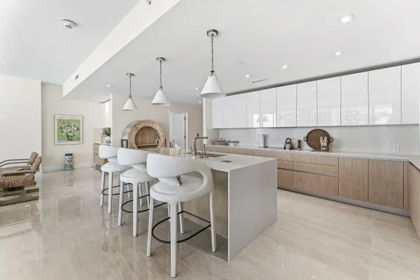 a kitchen with furniture a sink a window and a clock