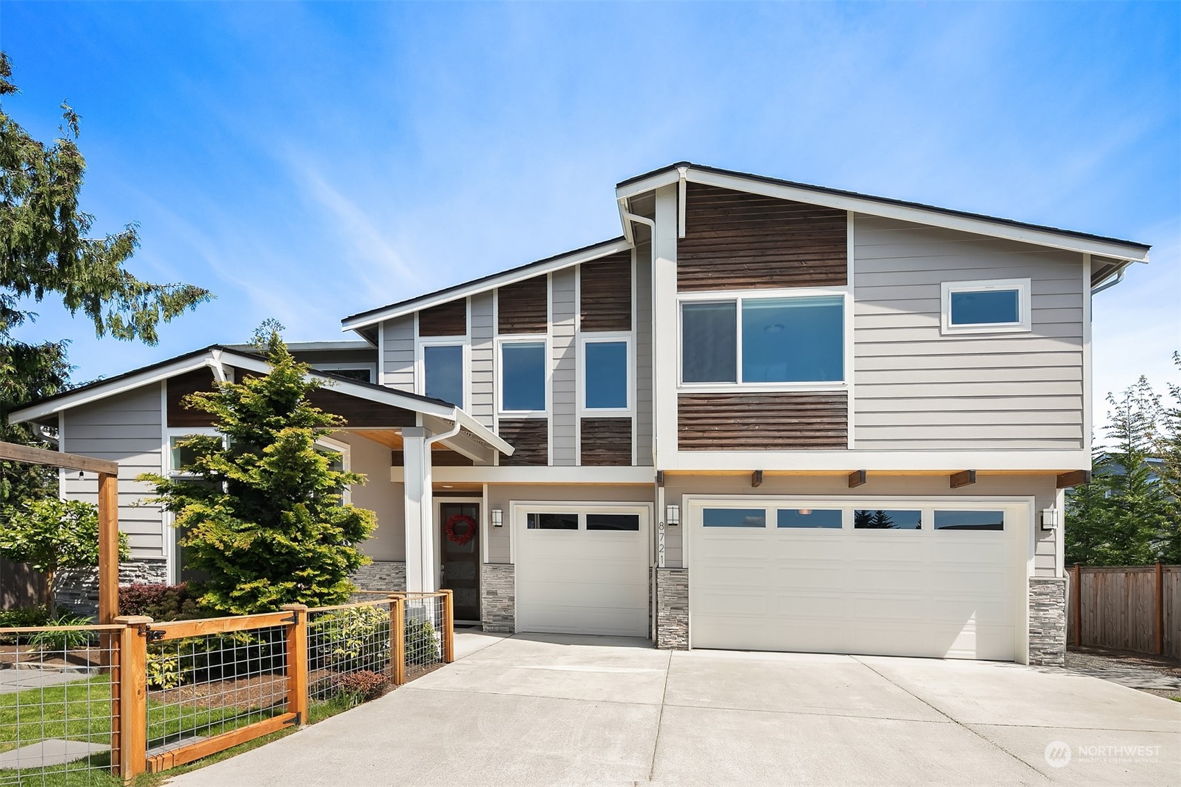 a front view of a house with plants