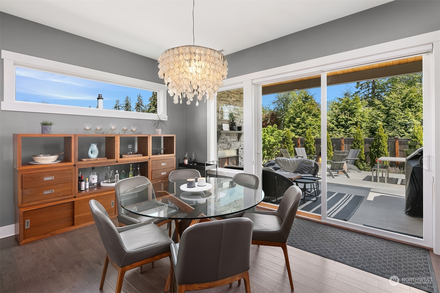 8721 218th Street Southwest Edmonds, WA 98026 - Photo 12 of 34 a view of a dining room with furniture a chandelier and large windows