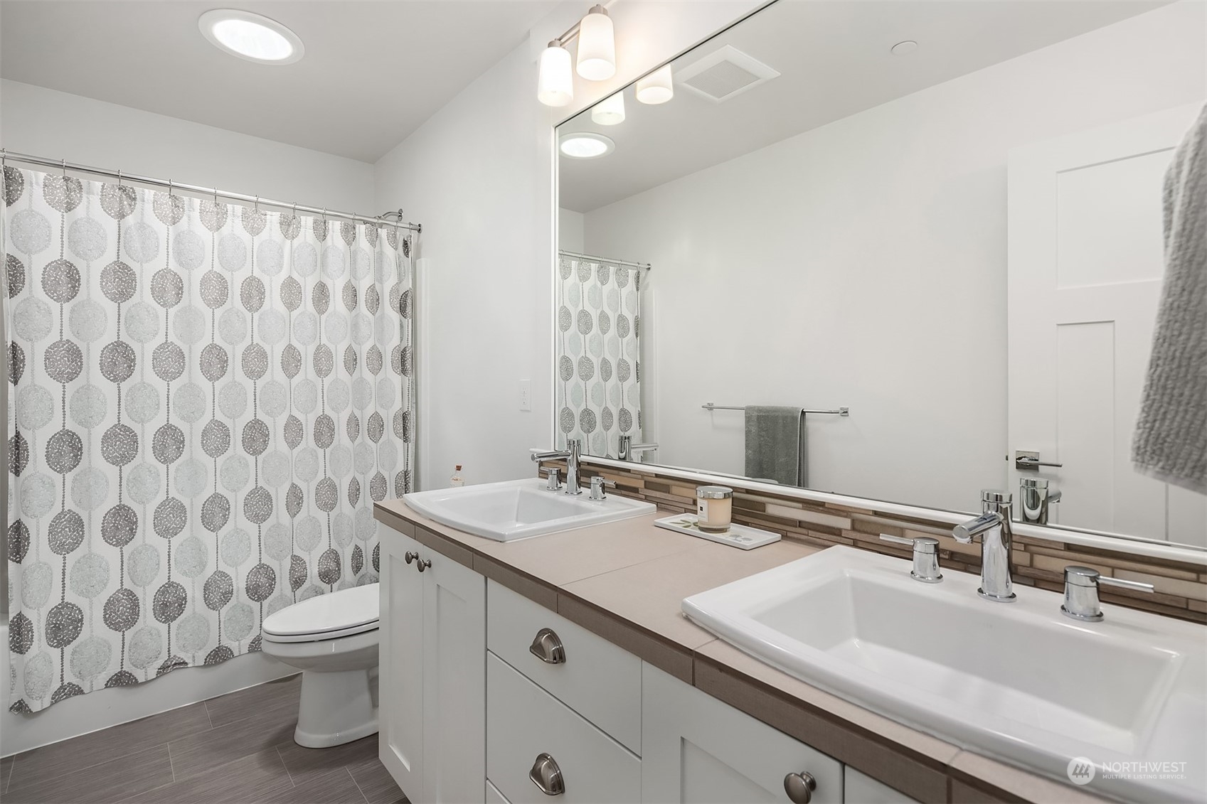 8721 218th Street Southwest Edmonds, WA 98026 - Photo 24 of 34 a bathroom with a double vanity sink toilet and a mirror