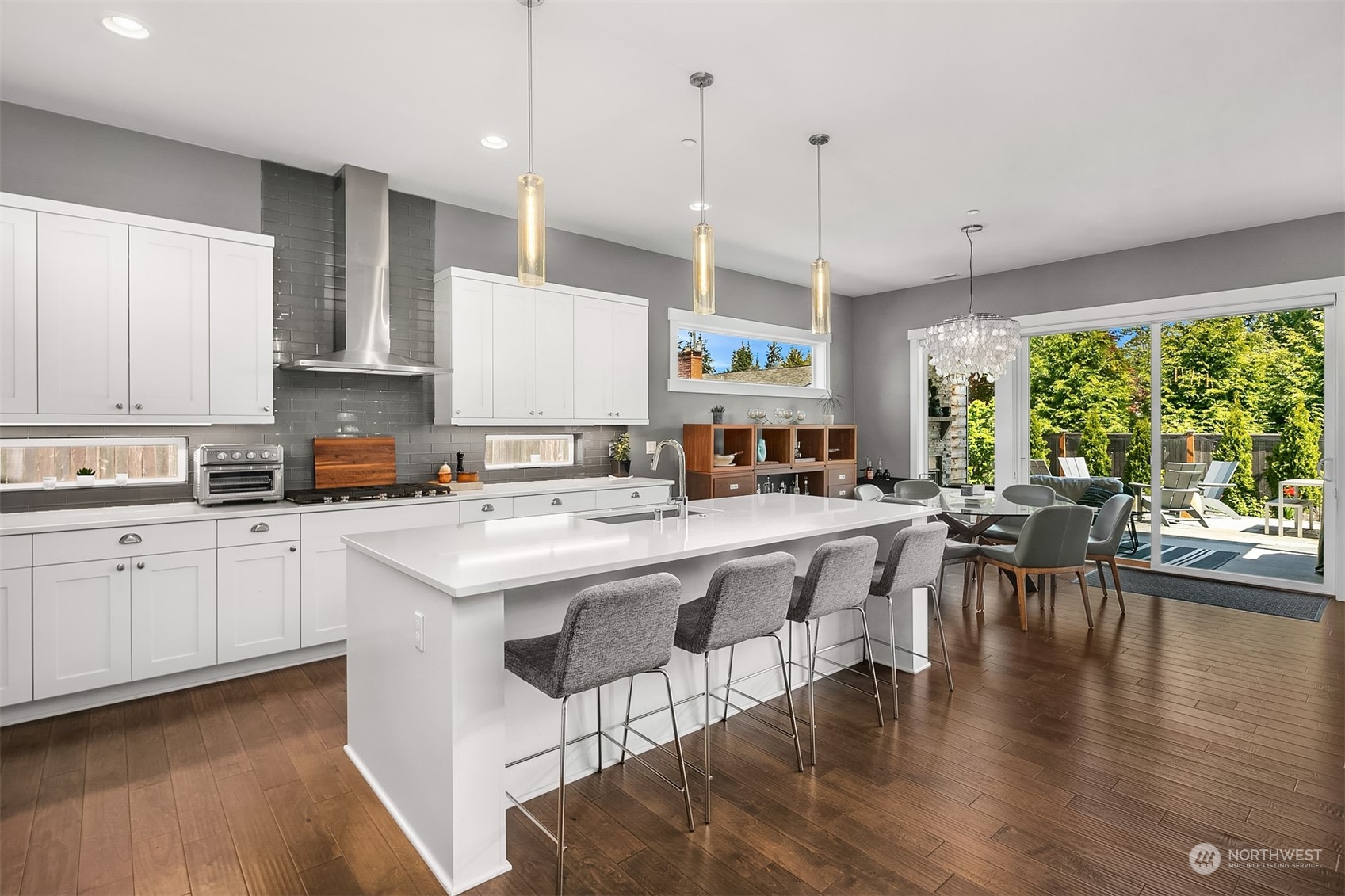 8721 218th Street Southwest Edmonds, WA 98026 - Photo 7 of 34 a kitchen with stainless steel appliances granite countertop a stove top oven a sink a stove and white cabinets with wooden floor