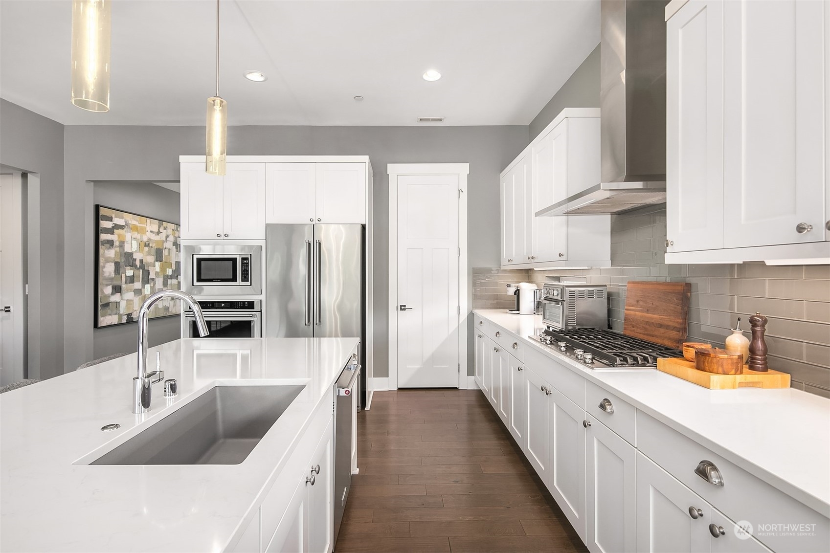 8721 218th Street Southwest Edmonds, WA 98026 - Photo 10 of 34 a kitchen with stainless steel appliances kitchen island granite countertop a sink refrigerator and cabinets