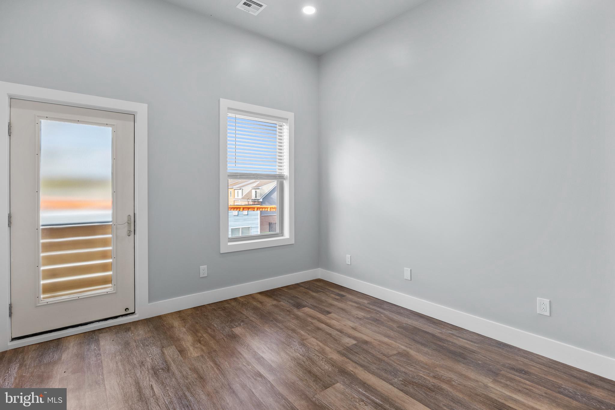 342 West Queen Lane, Unit 5 Philadelphia, PA 19144 - Photo 15 of 18 wooden floor in an empty room with a window