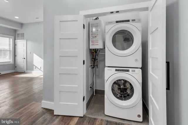 a utility room with sink dryer and washer