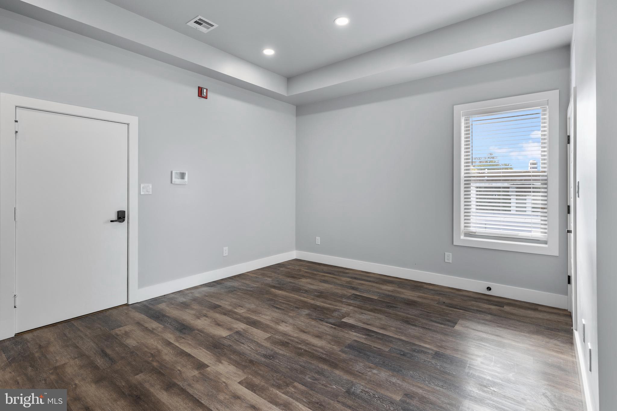 342 West Queen Lane, Unit 5 Philadelphia, PA 19144 - Photo 7 of 18 an empty room with wooden floor and windows