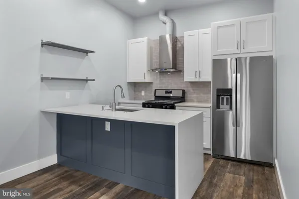 a kitchen with stainless steel appliances a refrigerator sink and cabinets