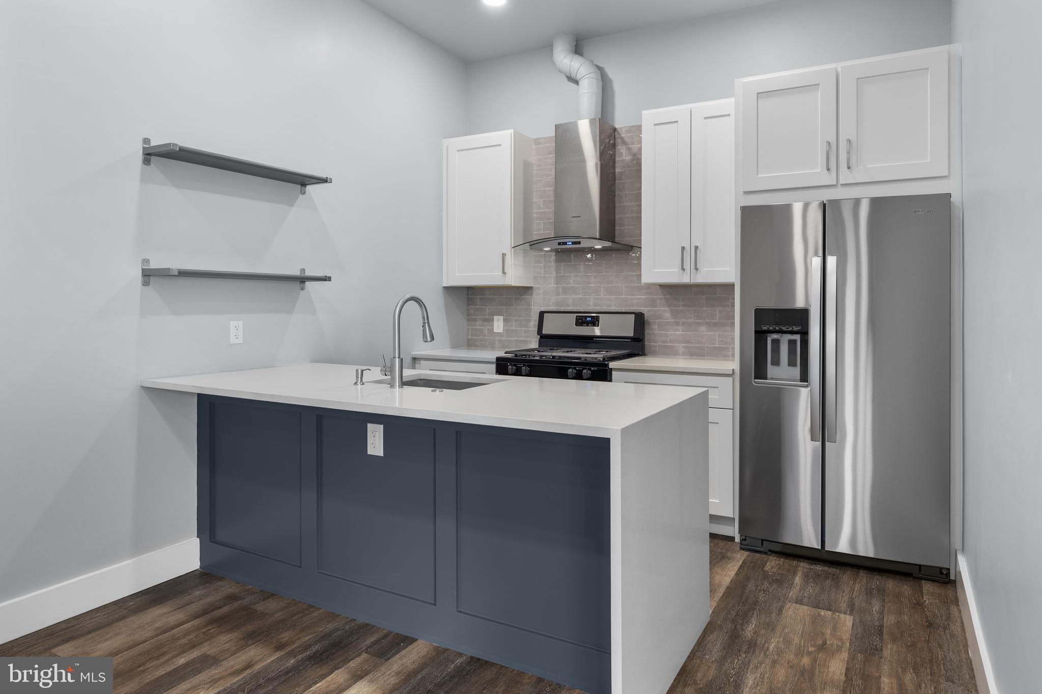 342 West Queen Lane, Unit 5 Philadelphia, PA 19144 - Photo 8 of 18 a kitchen with stainless steel appliances a refrigerator sink and cabinets