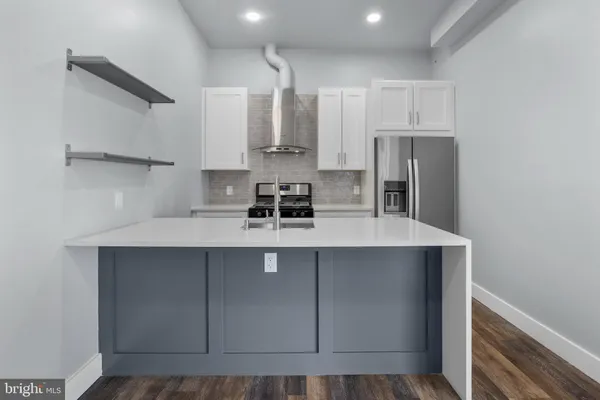a kitchen with stainless steel appliances a sink stove and cabinets
