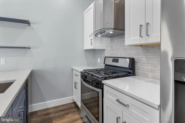 a stove top oven sitting inside of a kitchen