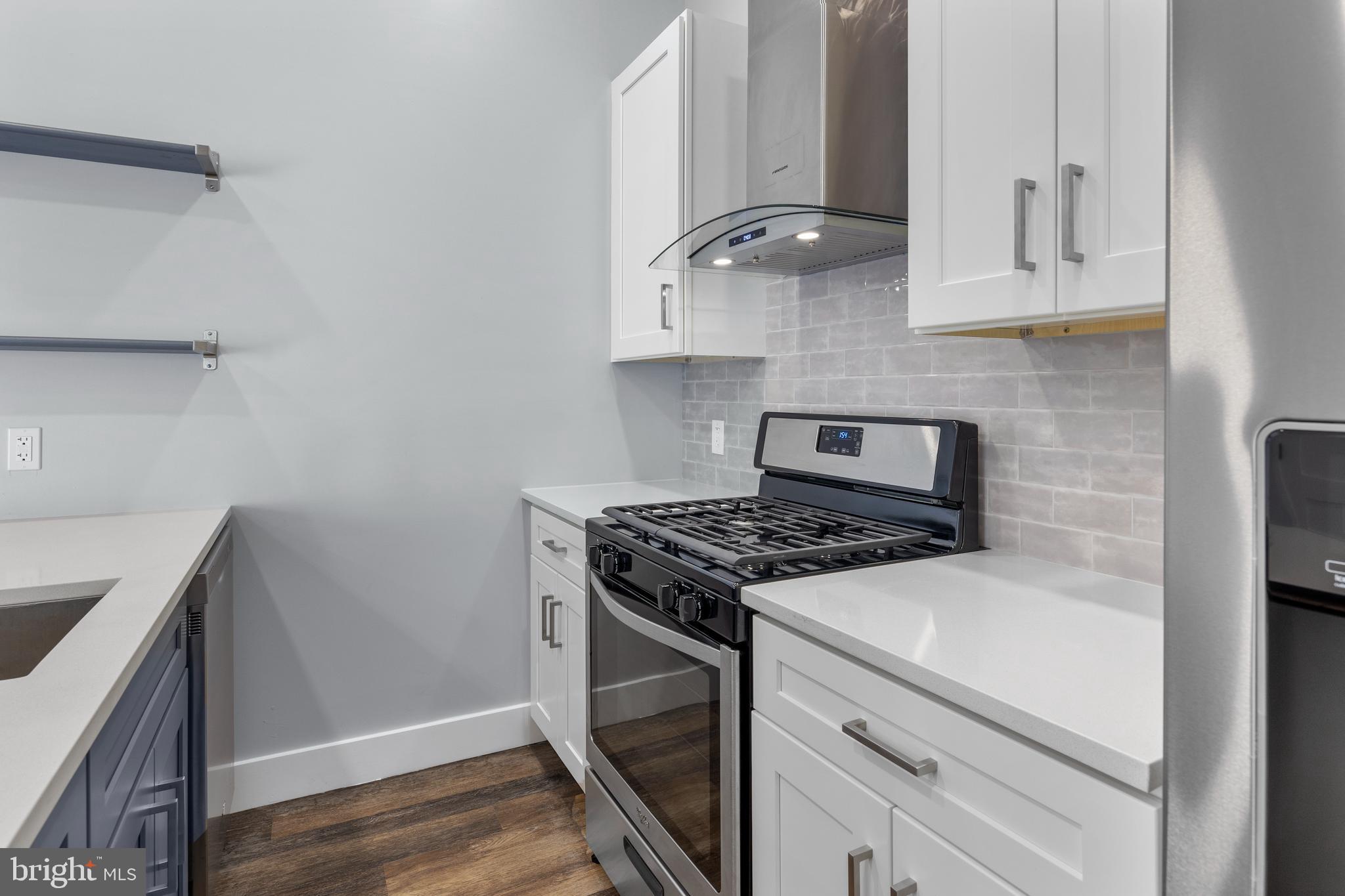 342 West Queen Lane, Unit 5 Philadelphia, PA 19144 - Photo 10 of 18 a stove top oven sitting inside of a kitchen