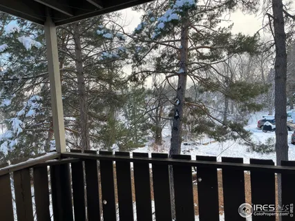 a view of a balcony with wooden fence and floor