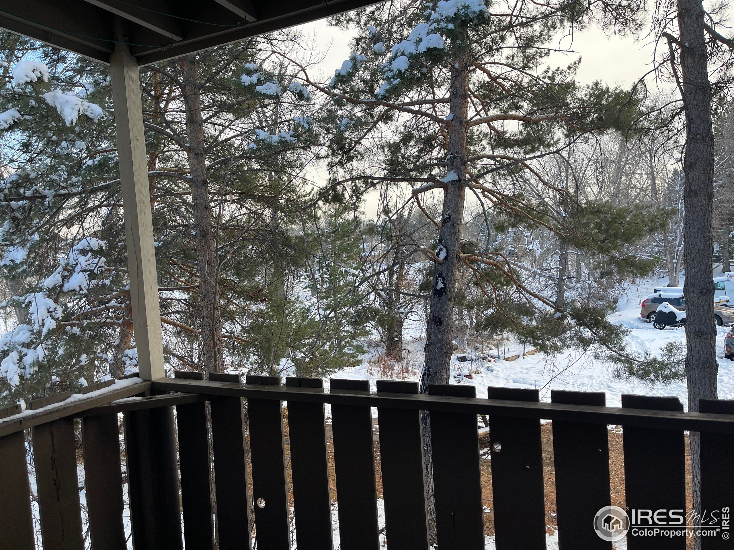 8060 Niwot Road, Unit 66 Niwot, CO 80503 - Photo 10 of 17 a view of a balcony with wooden fence and floor
