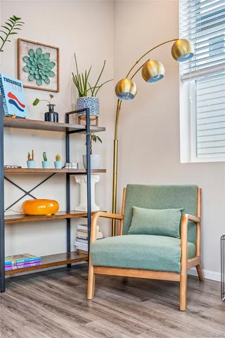 a living room with furniture a rug and a wall painting