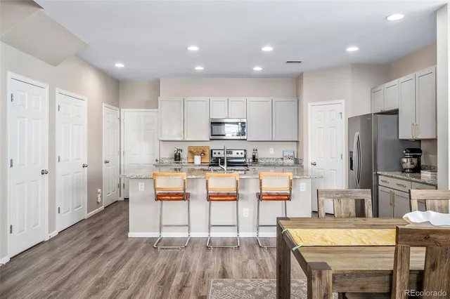 a room with wooden floors and windows