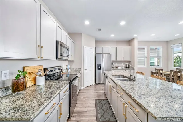 a kitchen with stainless steel appliances granite countertop a stove and a microwave