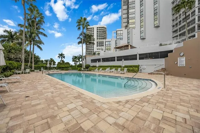 a swimming pool with outdoor seating and yard