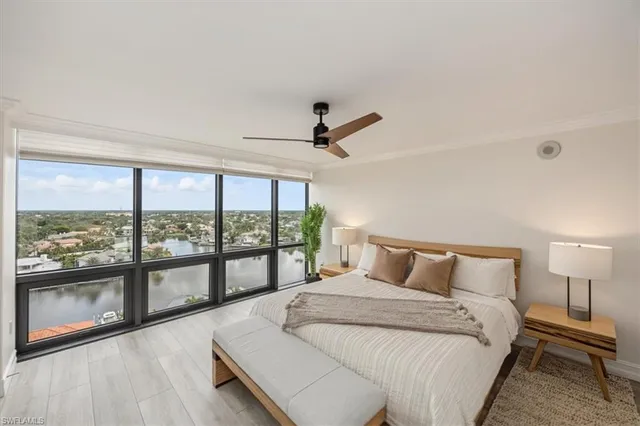 a bedroom with a large bed and a large window