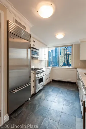 a kitchen with a refrigerator and a sink