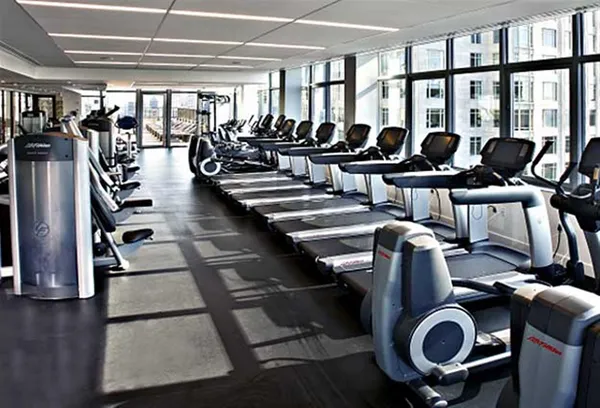 a gym room with lots of chairs and mirrors