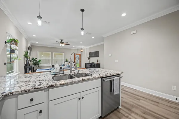 a kitchen with a sink and chandelier