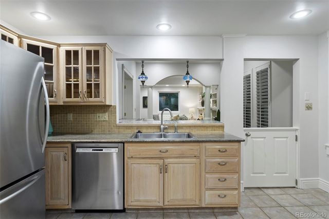 a kitchen with appliances a sink and lots of cabinets