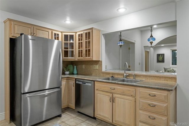 a kitchen with stainless steel appliances granite countertop a stove and a sink