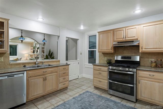 a kitchen with stainless steel appliances granite countertop a stove and a refrigerator