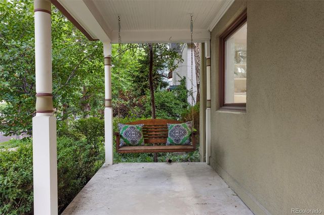 a view of backyard with plants and outdoor seating