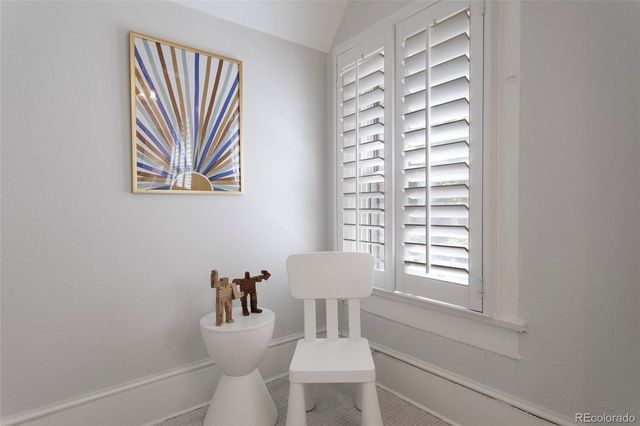 a bedroom with a bed and chair