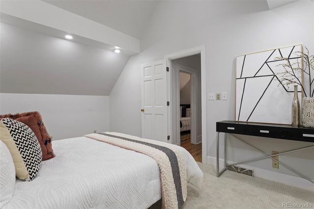 a bedroom with a bed and a chair