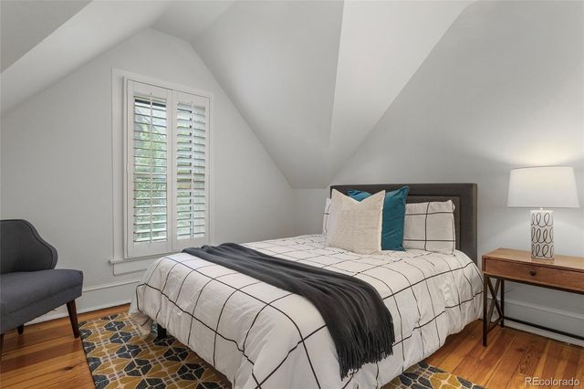 a bedroom with a bed and a night stand