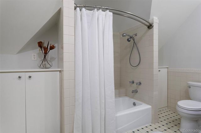 a bathroom with a granite countertop sink a toilet and a mirror