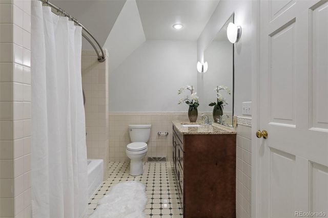 a living room with furniture and a blue wall