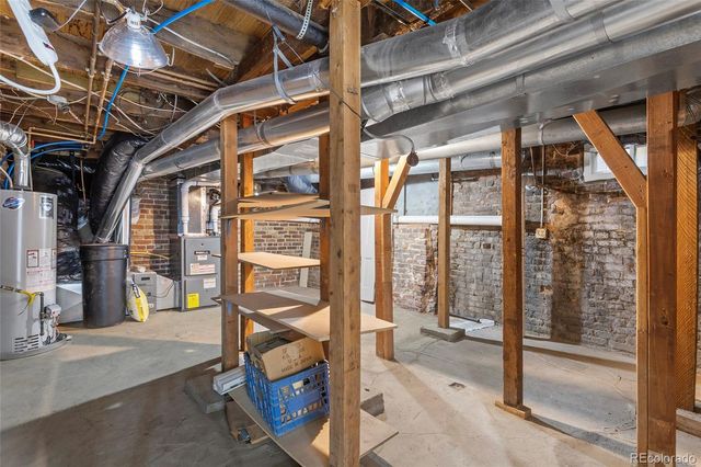 a front view of house with a garden and trees