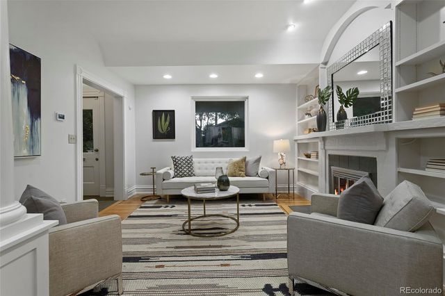 a dining room with furniture and wooden floor