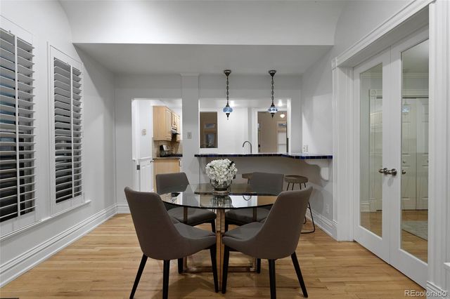 a dining room with furniture and wooden floor