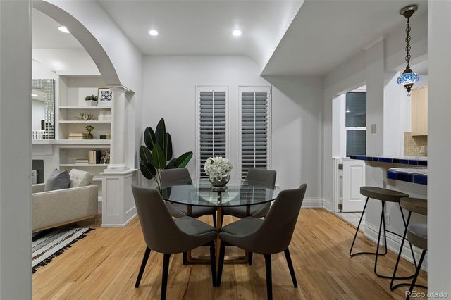 a kitchen with cabinets wooden floor and stainless steel appliances