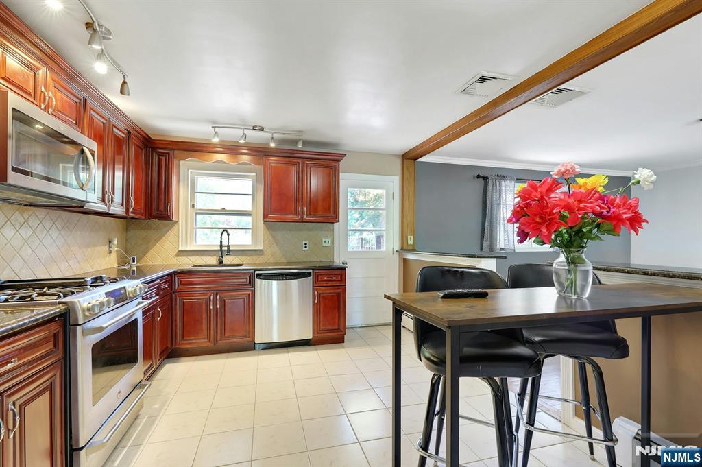 20 Blue Hill Road Norwood, NJ 07648 - Photo 14 of 49 a kitchen with granite countertop a sink cabinets stainless steel appliances and a window