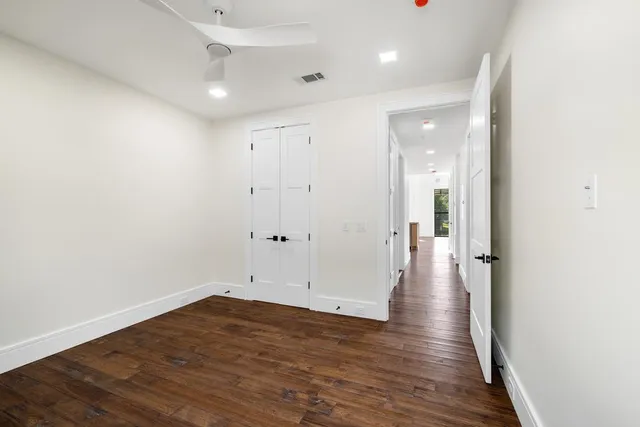 a view of a hallway with wooden floor