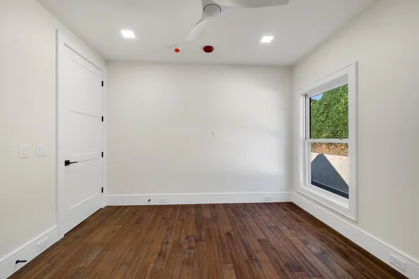 a view of room with window and hardwood floor