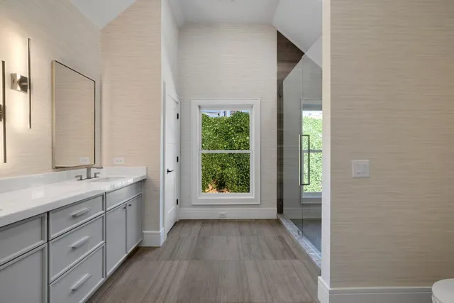 a view of a bathroom with two sinks and a window