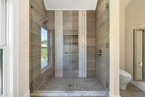 a bathroom with a shower and toilet