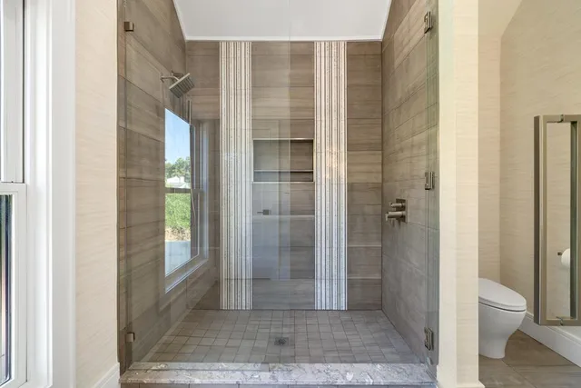 a bathroom with a shower and toilet