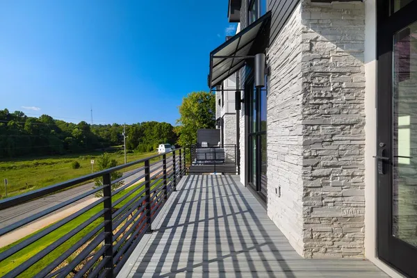 a view of balcony with wooden floor and fence