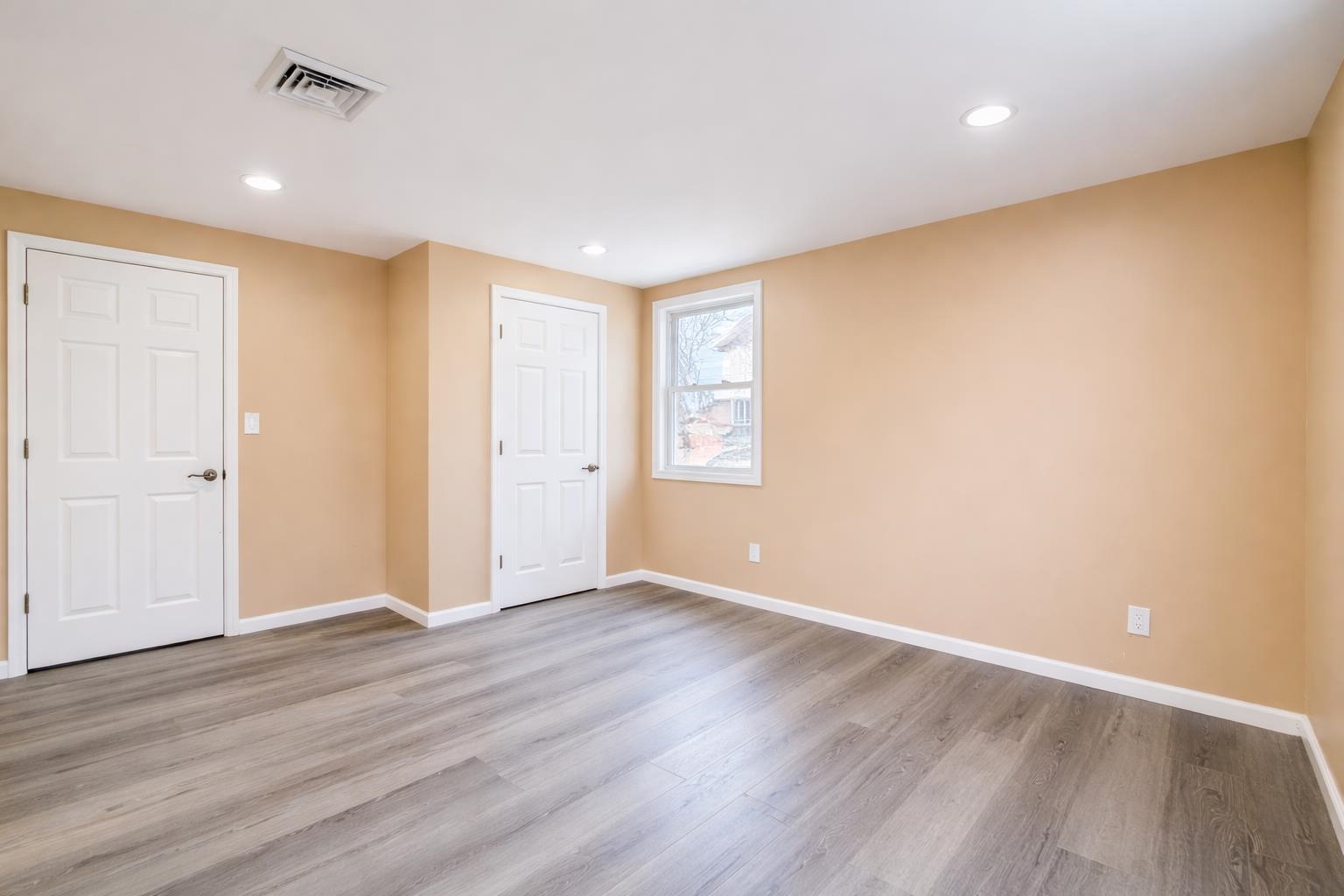 1572 Summit Avenue, Unit 2 Hillside, NJ 07205 - Photo 12 of 20 an empty room with wooden floor and windows