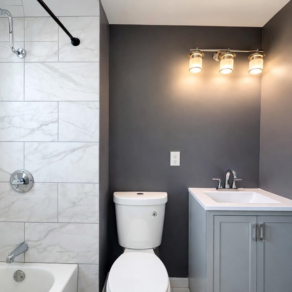 1572 Summit Avenue, Unit 2 Hillside, NJ 07205 - Photo 14 of 20 a bathroom with a toilet sink and mirror