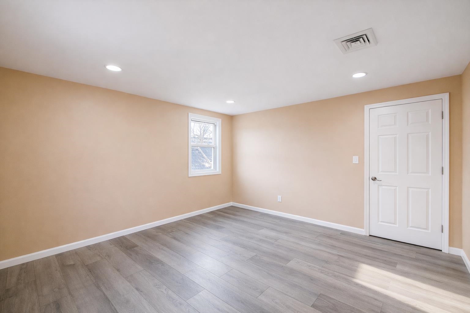 1572 Summit Avenue, Unit 2 Hillside, NJ 07205 - Photo 16 of 20 a view of an empty room with wooden floor and a window
